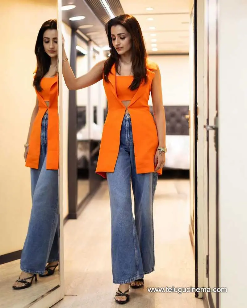 Trisha stuns in a tangerine-hued top